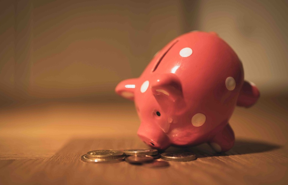 red piggy bank with coins